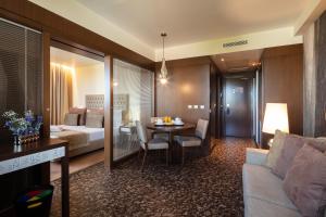 a hotel room with a couch and a table at NEYA Lisboa Hotel in Lisbon
