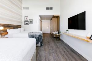 a hotel room with two beds and a flat screen tv at Glacier View Lodge in Sunwapta