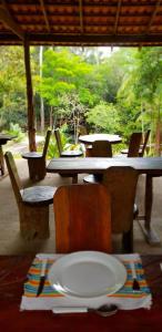 a table and chairs with a plate on a table at Aldeia Mari-Mari Amazon Lodge in Presidente Figueiredo