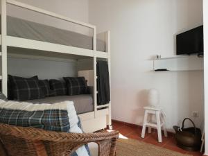 a bedroom with a bunk bed with a mirror at Casa Típica Algarvia in Cabanas de Tavira