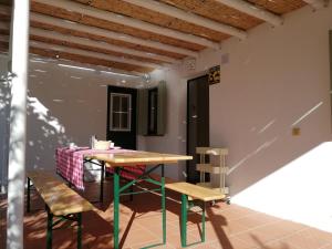 a table and two chairs in a room with a table at Casa Típica Algarvia in Cabanas de Tavira
