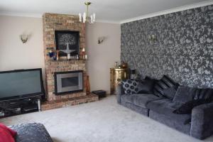 a living room with a couch and a fireplace at Nottingham City House in Nottingham