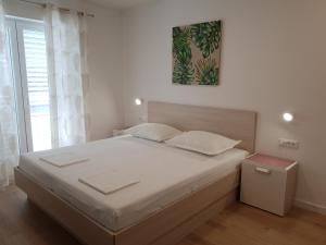 Postel nebo postele na pokoji v ubytování Guesthouse Dominović