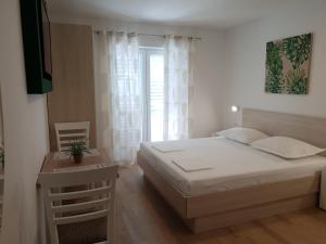 Postel nebo postele na pokoji v ubytování Guesthouse Dominović