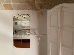 a mirror on the wall next to a door at Buon Consiglio B&B in Lecce