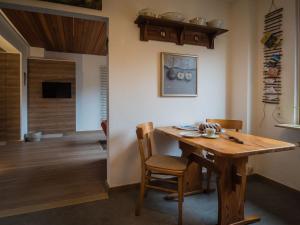 a dining room with a wooden table and chairs at Antel 42 in Andernach
