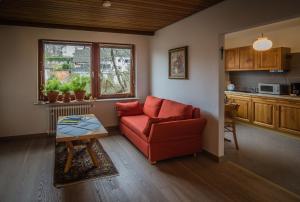 ein Wohnzimmer mit einem roten Sofa und einem Tisch in der Unterkunft Antel 42 in Andernach