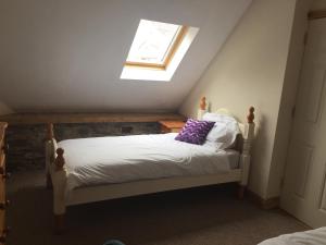 a small bedroom with a bed with a window at Redington House SelfCatering accommodation in Cobh