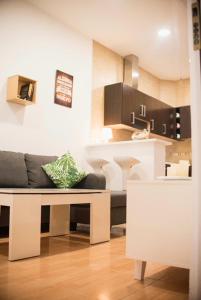 a living room with a couch and a kitchen at NICE HOME city center in Melilla