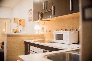 a kitchen with a sink and a microwave at NICE HOME city center in Melilla +6 photos