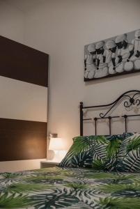 a bedroom with a bed with a green and white comforter at NICE HOME city center in Melilla