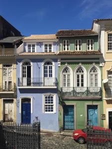 a house with a red car parked in front of it at Bahia Pelô Hostel in Salvador