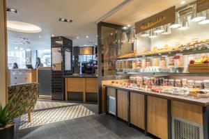a store with a counter with food on it at Point A London Liverpool Street in London