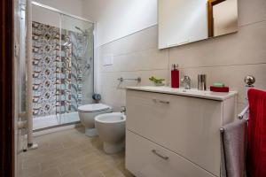 a bathroom with a toilet and a sink and a shower at Annina'S Home Panoramic sea view By Sicily Home Solutions in Castellammare del Golfo +41 photos
