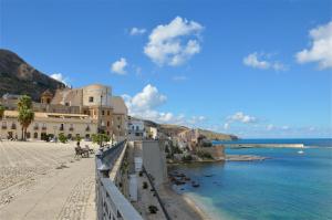 a view of a beach with buildings and the water at Annina'S Home Panoramic sea view By Sicily Home Solutions in Castellammare del Golfo