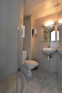 a bathroom with a toilet and a sink at Face West Le Pontet in Le Pontet
