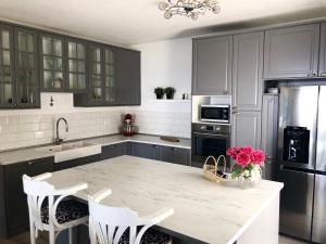 a kitchen with a marble counter top and a kitchen island at Apartments Aman in Makarska