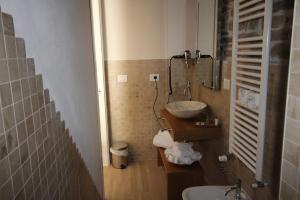 a bathroom with a sink and a mirror at MIRUTT by Keyhole Selection in Castelmezzano