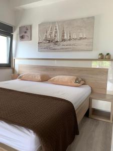 a bedroom with a large bed with sails on the wall at Apartmani Emilio Novalja in Novalja