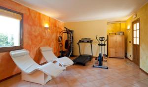 a room with a gym with two chairs and a treadmill at Ai Casali in Cividale del Friuli
