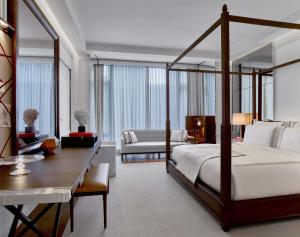 a bedroom with a bed and a desk and a room at Baccarat Hotel and Residences New York in New York