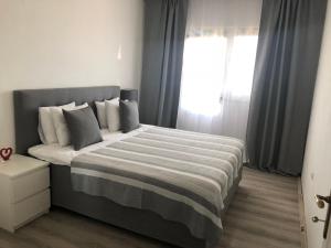 a bedroom with a large bed with a window at Apartments Aman in Makarska