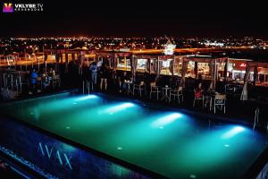 a swimming pool on the roof of a building at night at Grand Spa Hotel Avax in Krasnodar