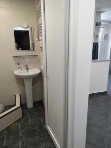 a small bathroom with a sink and a mirror at Apartment Eteri in Batumi +43 photos