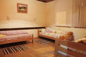 a room with two beds and a couch in it at Apartman Baron in Višegrad