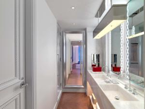 a bathroom with two sinks and a mirror at Baccarat Hotel and Residences New York in New York