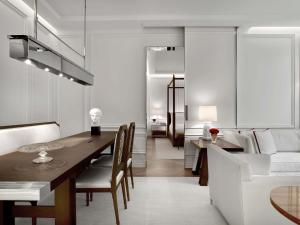 a dining room and living room with a table and a couch at Baccarat Hotel and Residences New York in New York