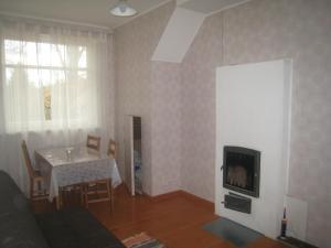 a living room with a table and a tv at Sae Hostel in Võsu