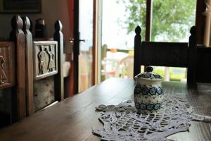 a vase sitting on top of a wooden table at Ai Canarbin - colline di Lerici in Lerici +28 photos