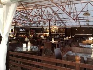 a dining room with tables and chairs in a restaurant at Palm trees in Ureki