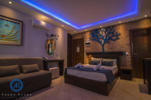 a bedroom with a bed and a couch at Kappa Rooms in Nea Kalikratia