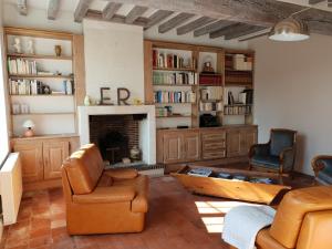 a living room with a couch and a fireplace at la blanchetière in Francueil