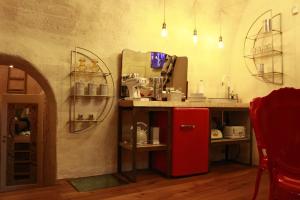 a kitchen with a red refrigerator in a room at Casa Linda in Matera