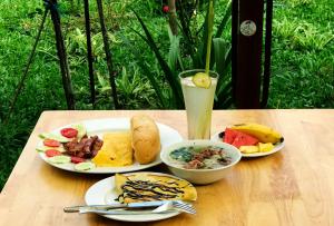 a table with two plates of food and a drink at May Homestay - Tam Coc Local Village in Ninh Binh