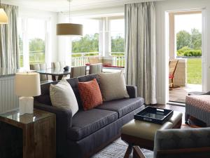 a living room with a couch and a table at Inn By the Sea in Cape Elizabeth
