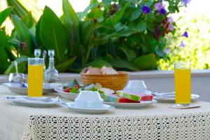 a table with plates of food and glasses of orange juice at B&B Garni Stefi! in Supetarska Draga