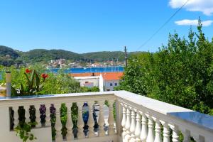 a white balcony with a view of a city at B&B Garni Stefi! in Supetarska Draga +12 photos