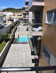 a view from the balcony of a building with a swimming pool at Quarportugal in São Martinho do Porto