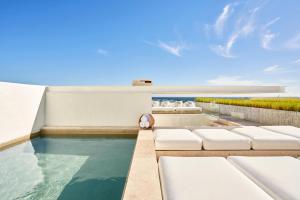 a swimming pool with a pool table and chairs at Viceroy Los Cabos in San José del Cabo