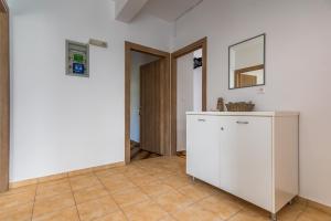 a room with a white cabinet and a mirror at Iliopoulou Studios in Pollonia