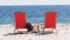 two chairs in the sand on the beach at Inn By the Sea in Cape Elizabeth