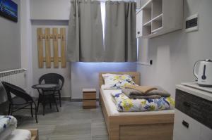 a room with two beds and a table and chairs at OLIVIA in Osiek