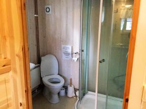a small bathroom with a toilet and a shower at Harran Camping in Grong +49 photos