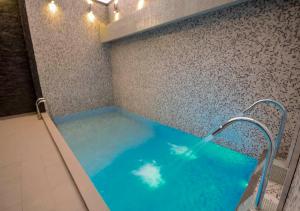 a large blue tub in a bathroom with lights at qp Hotels Trujillo in Trujillo