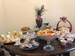 a table with a bunch of bread and pastries on it at B&B Al San Francesco in Castel di Sangro