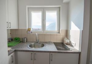 a kitchen with a sink and a window at Queen Teuta - Sea View - Private Parking & Garden - BBQ Grill in Risan +31 photos